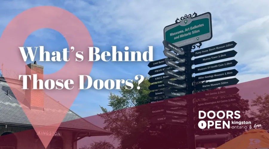 Directional sign listing local museums and attractions with the text 'What’s Behind Those Doors?' in bold, set against a historic building and blue sky, featuring the 'Doors Open Kingston Ontario & Area' logo in the corner.